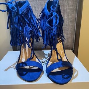 Royal blue heels with fringe around the ankles